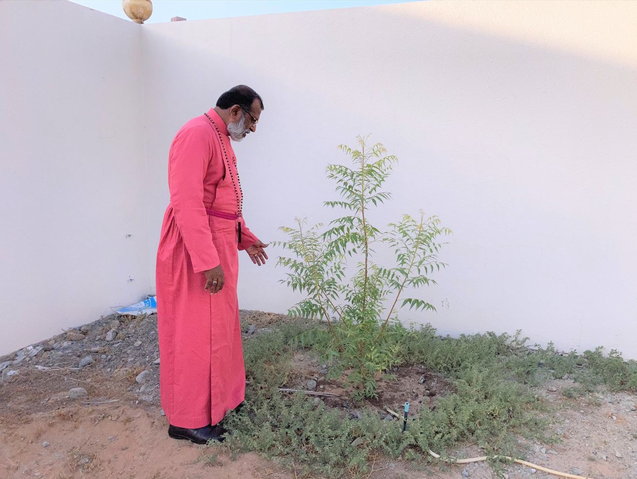 Bishop Rt. Rev. Dr. Malayil Sabu Koshy Cherian with the Neem Tree at Fujairah Church