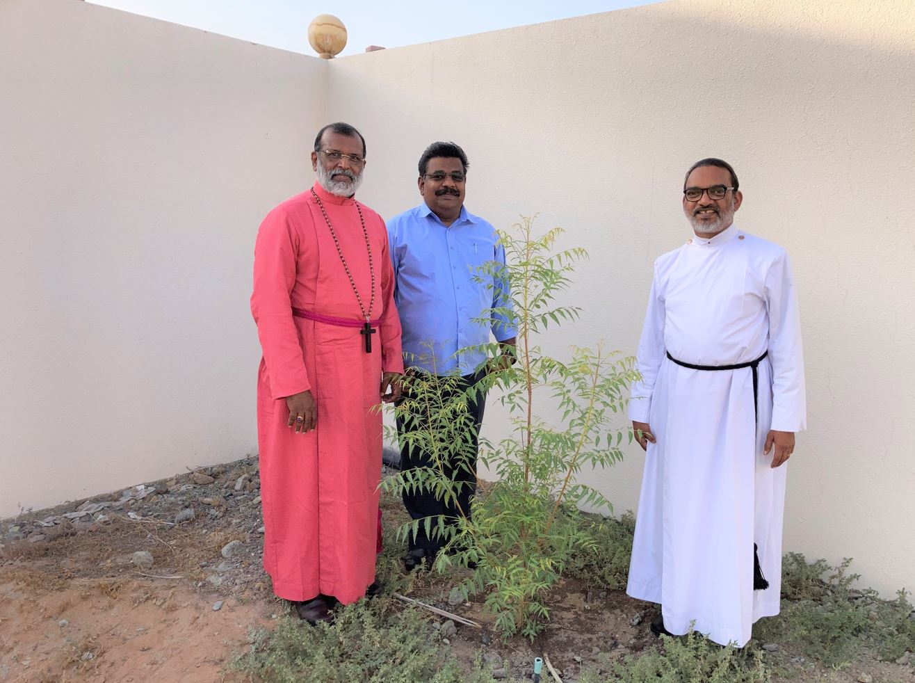 Bishop Rt. Rev. Dr. Malayil Sabu Koshy Cherian with the Neem Tree at Fujairah Church